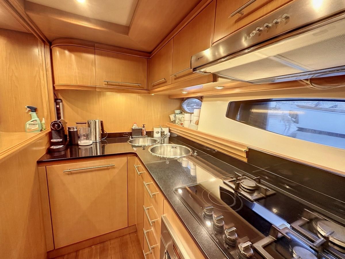 a kitchen with wooden cabinets aboard NAUTILUS Yacht for Sale