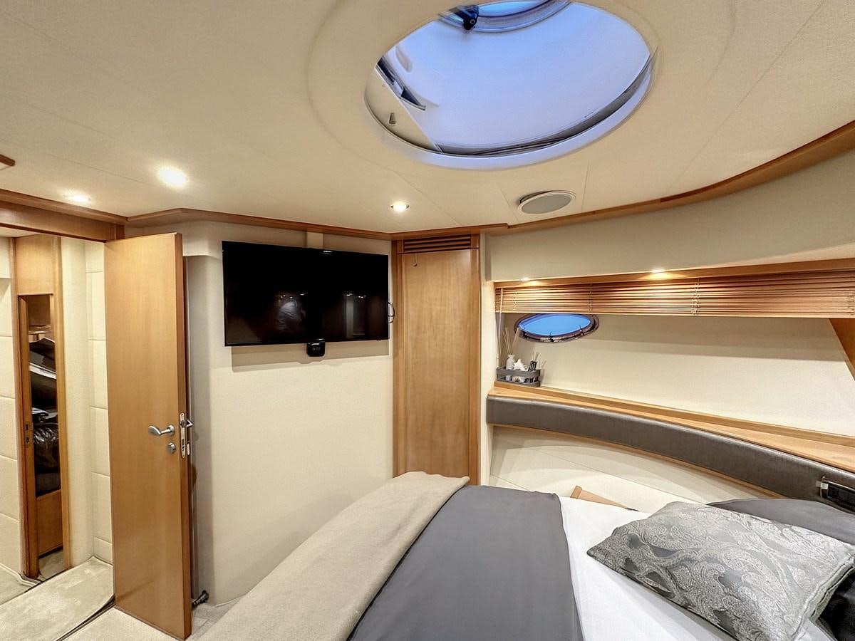 a room with a bed and a television aboard NAUTILUS Yacht for Sale