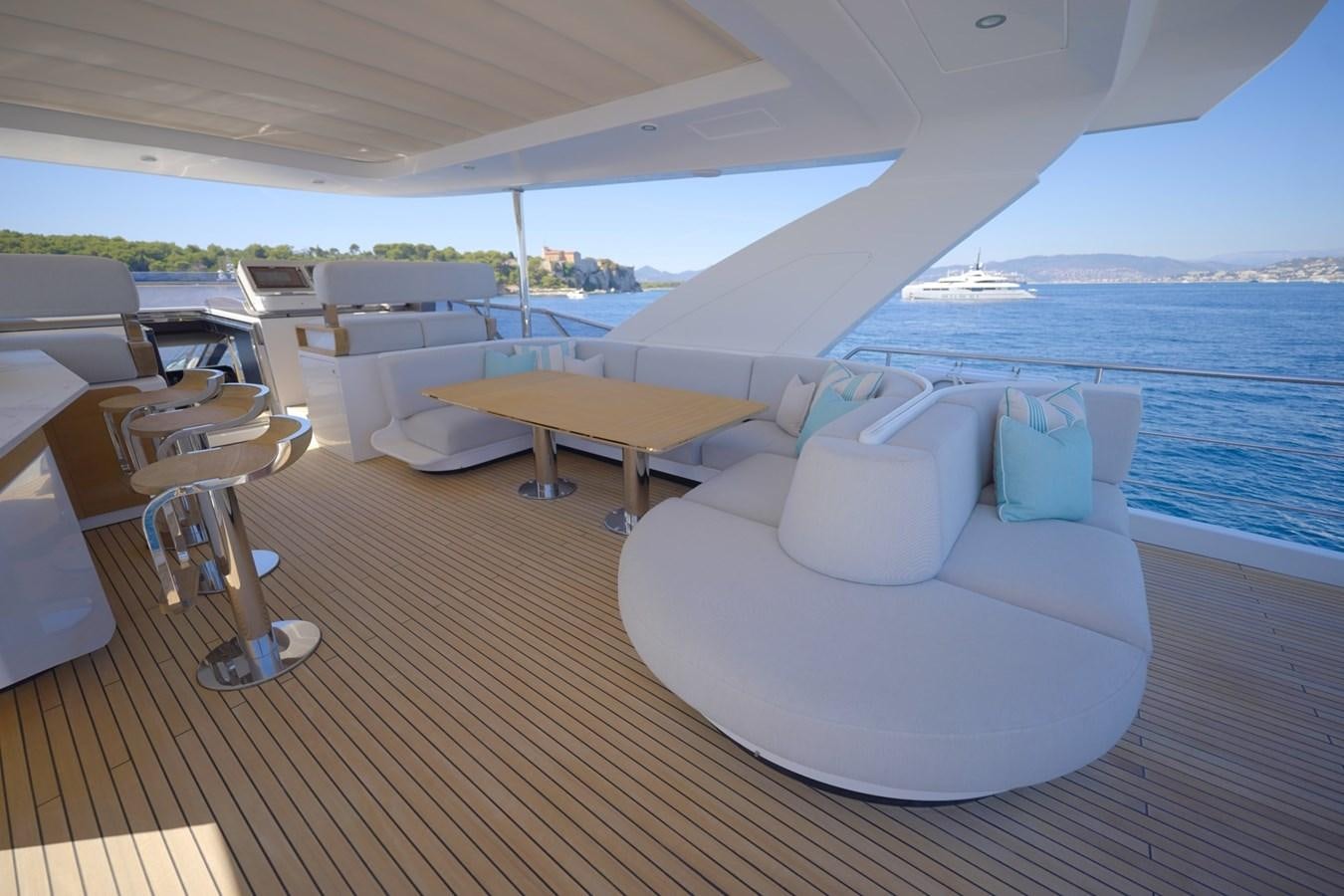 a room with a bed and a table and chairs aboard GRANDE 27M Yacht for Sale