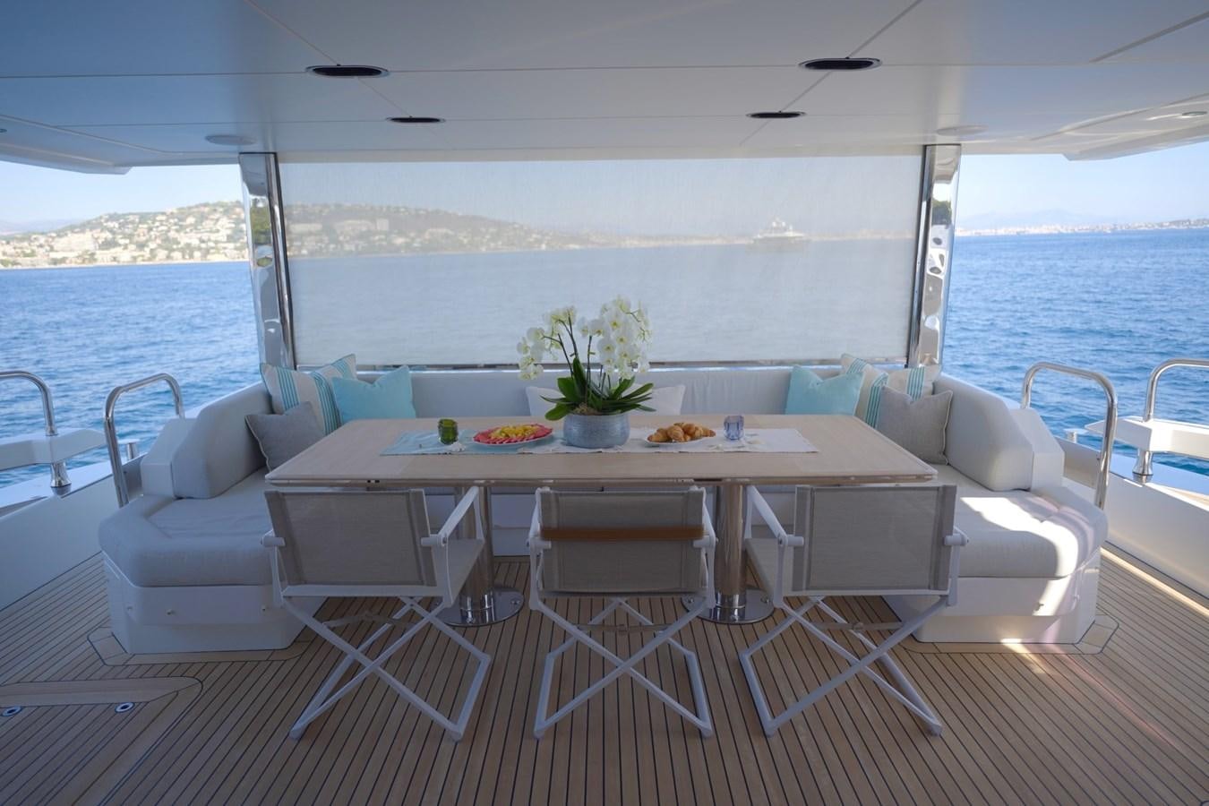 a table with chairs on it aboard GRANDE 27M Yacht for Sale