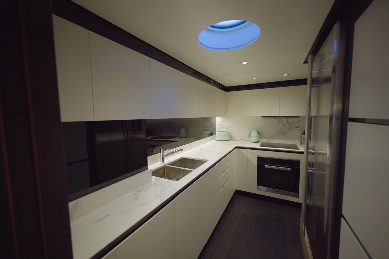 a kitchen with white cabinets aboard GRANDE 27M Yacht for Sale