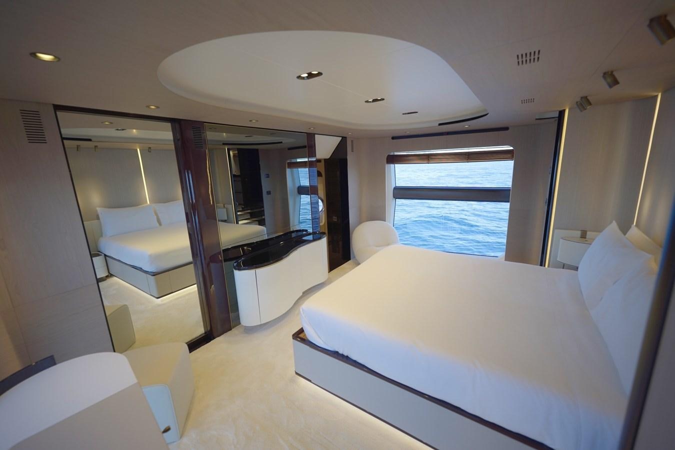 a room with a bed and a desk aboard GRANDE 27M Yacht for Sale