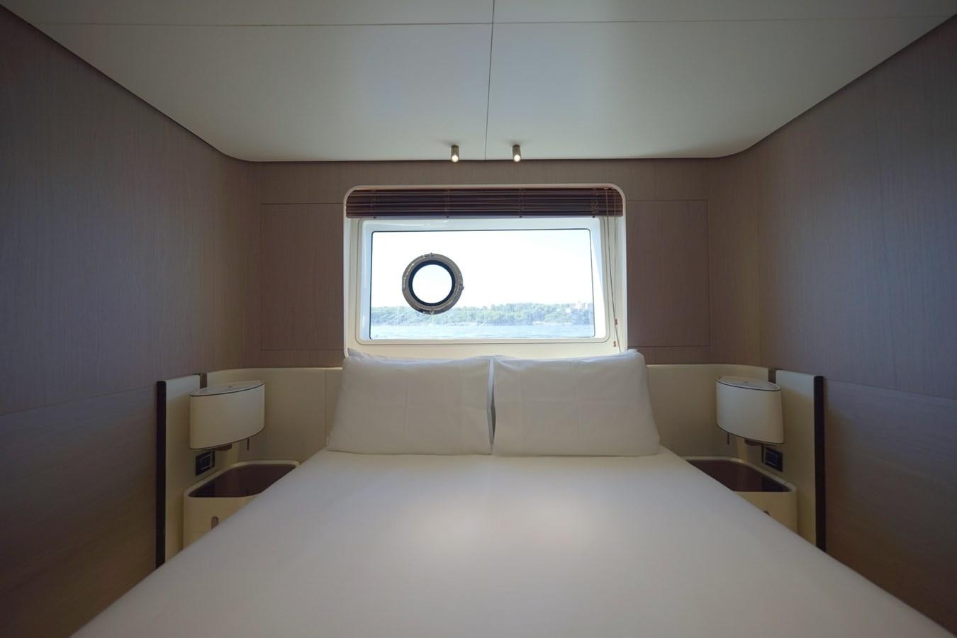 a bed with a large window aboard GRANDE 27M Yacht for Sale