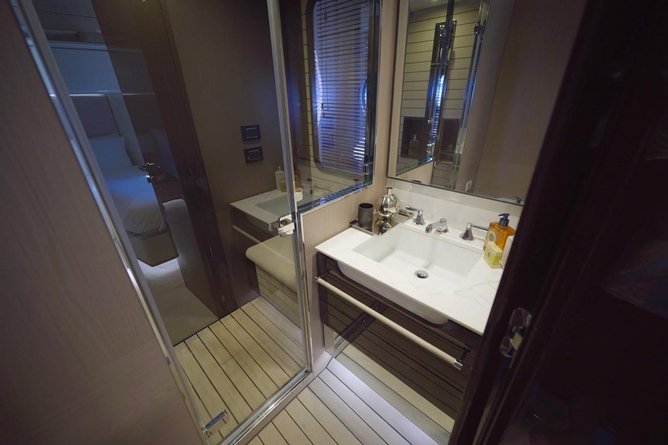 a bathroom with a tub sink and a mirror aboard GRANDE 27M Yacht for Sale