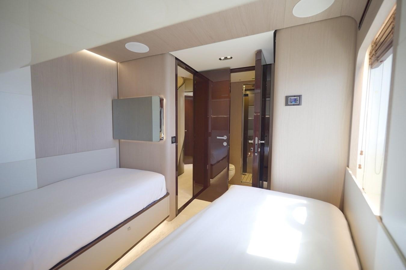 a room with a bed and a desk aboard GRANDE 27M Yacht for Sale