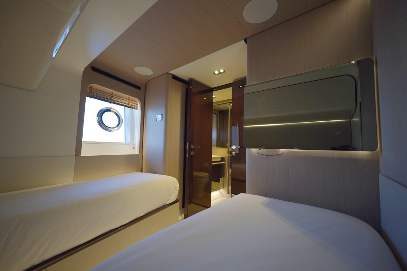 a room with beds and a mirror aboard GRANDE 27M Yacht for Sale