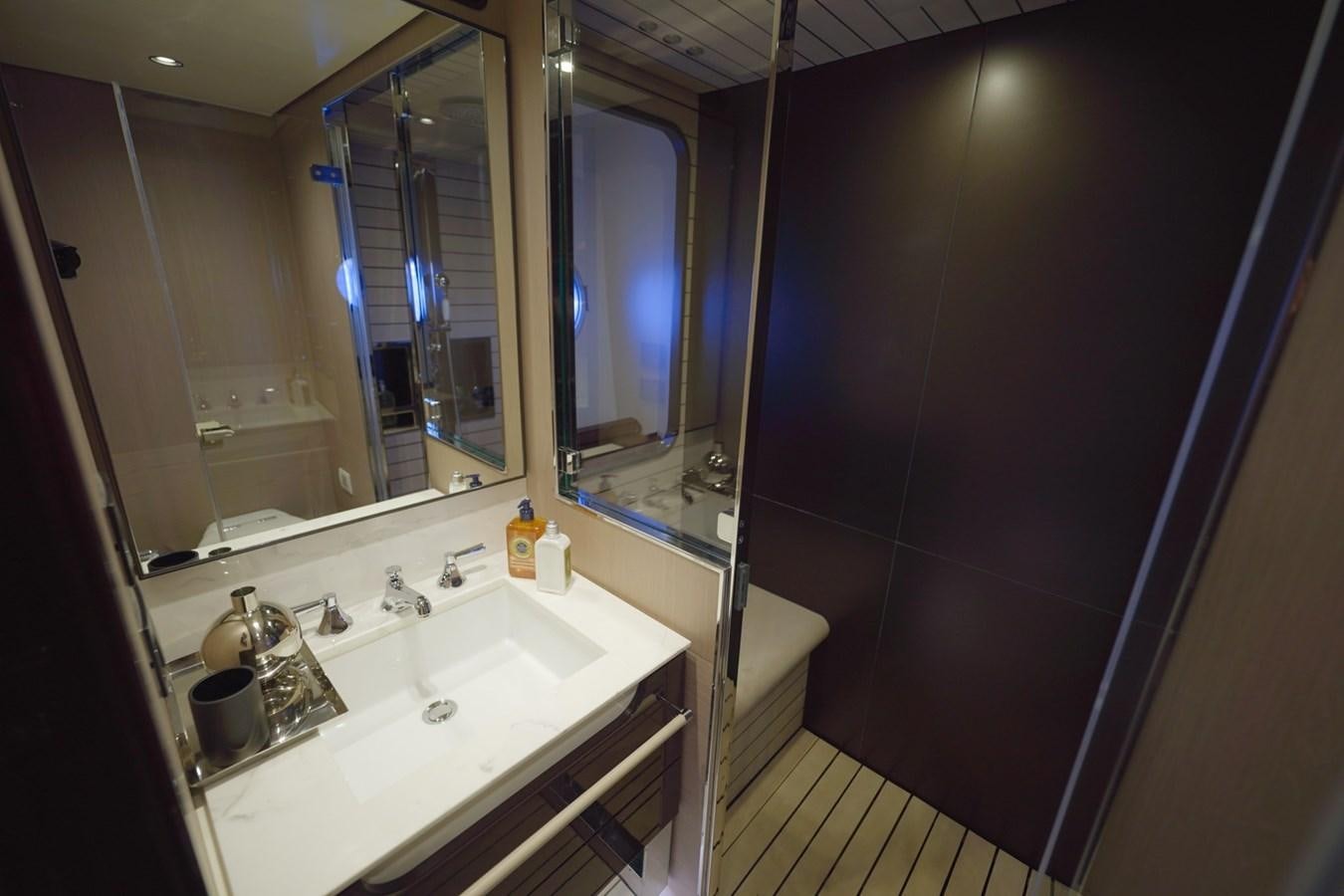 a bathroom with a sink and a large mirror aboard GRANDE 27M Yacht for Sale