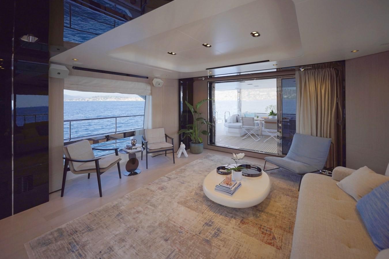 a living room with a large balcony aboard GRANDE 27M Yacht for Sale