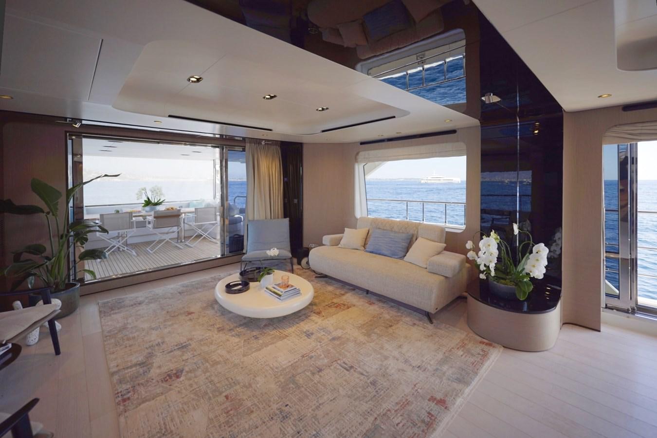 a living room with a large window aboard GRANDE 27M Yacht for Sale