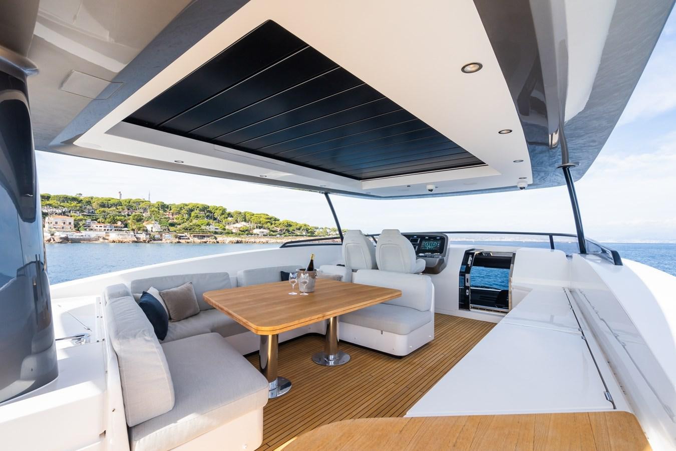 a room with a table and couches aboard SWG Yacht for Sale
