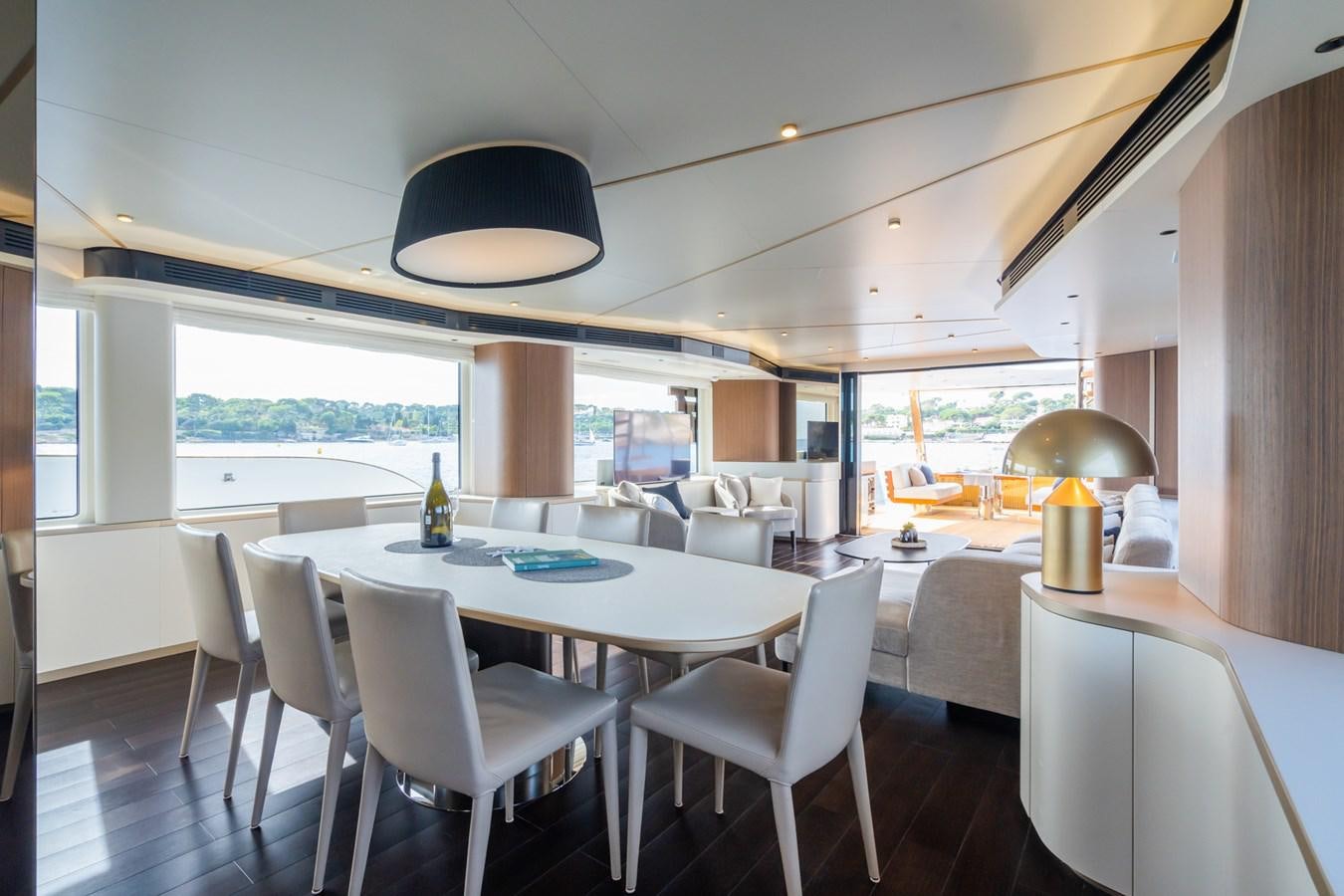 a large room with tables and chairs aboard SWG Yacht for Sale