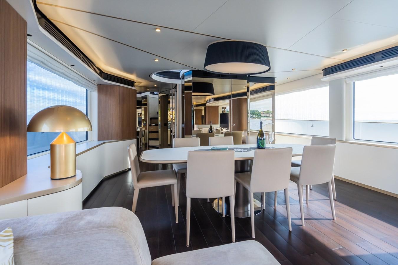a room with tables and chairs aboard SWG Yacht for Sale