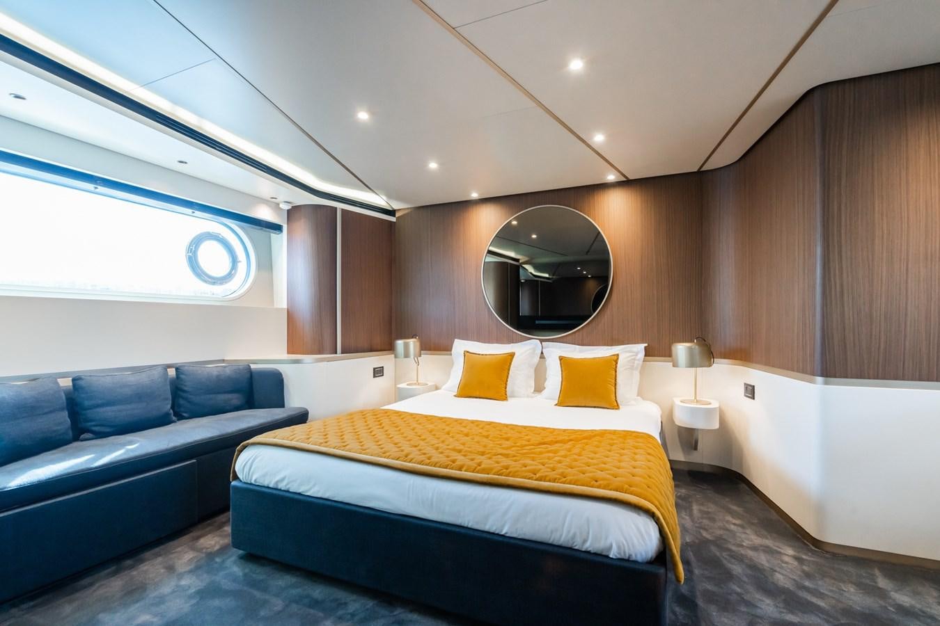 a room with a bed and a couch aboard SWG Yacht for Sale