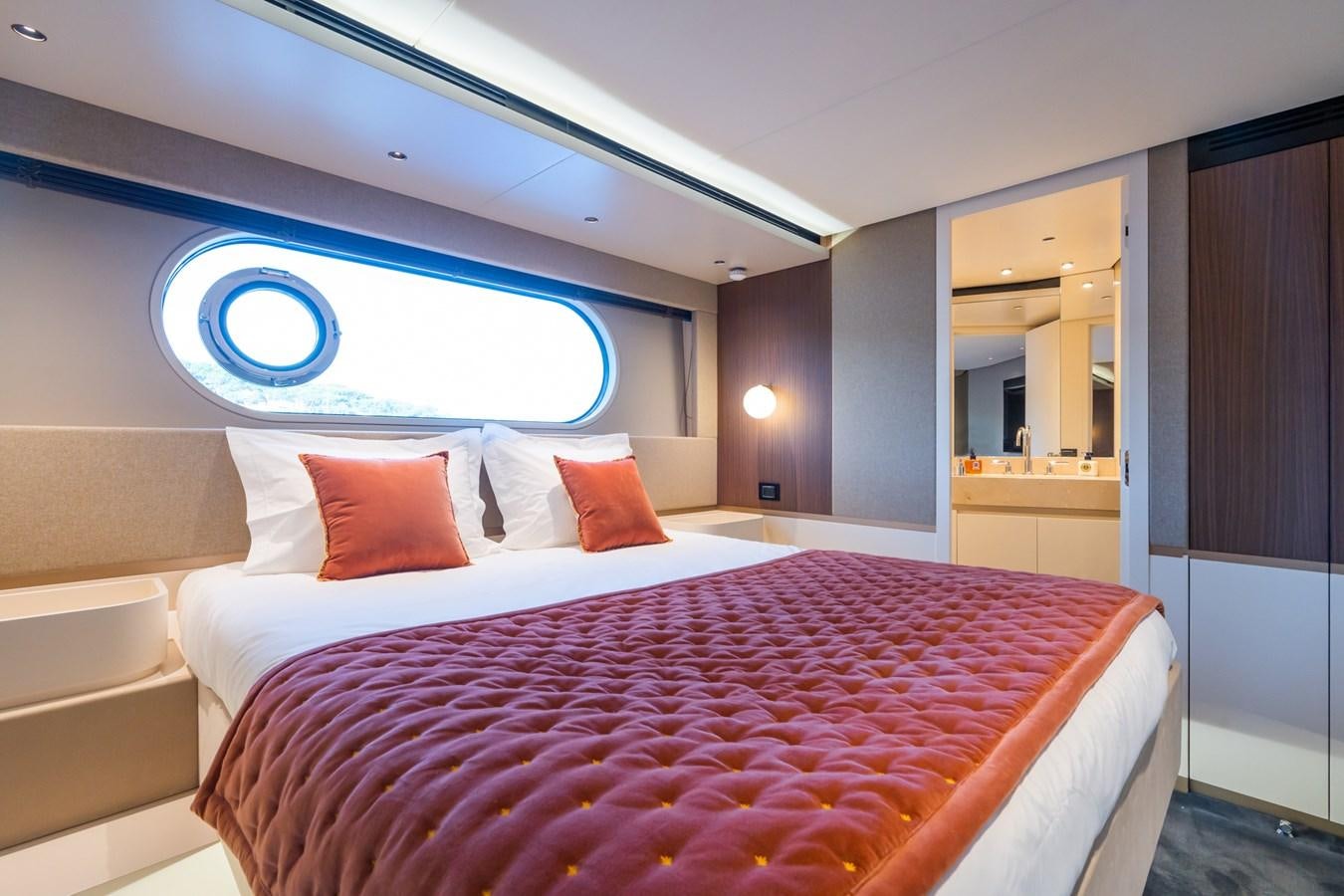 a bed with a pink comforter aboard SWG Yacht for Sale