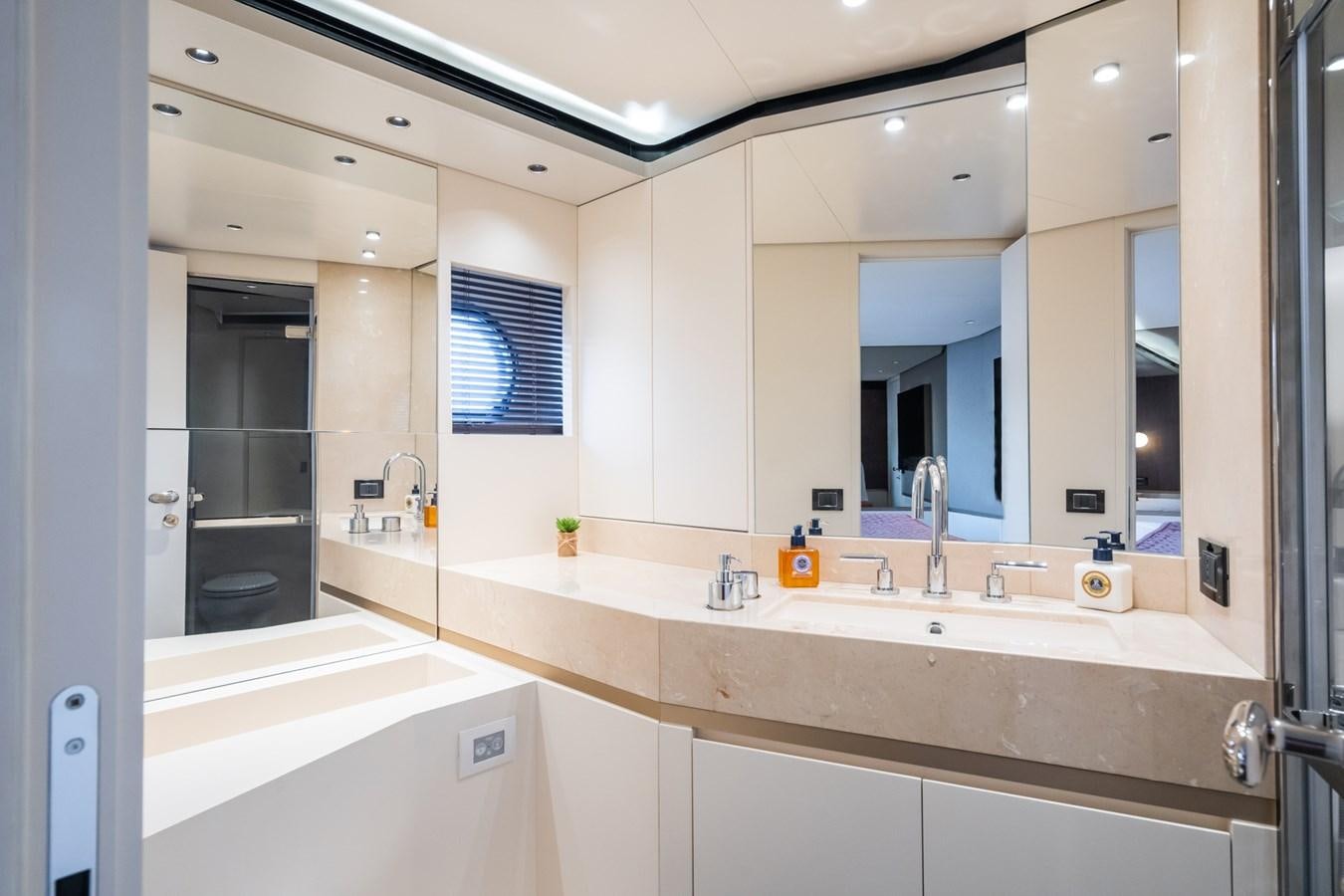 a bathroom with a large mirror aboard SWG Yacht for Sale