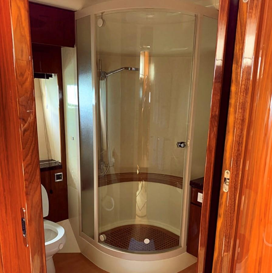 a bathroom with a glass shower aboard OCEANA Yacht for Sale