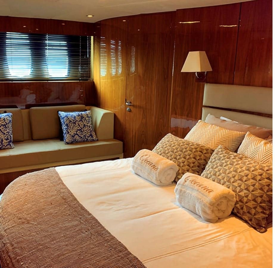 a room with a bed and a couch aboard OCEANA Yacht for Sale