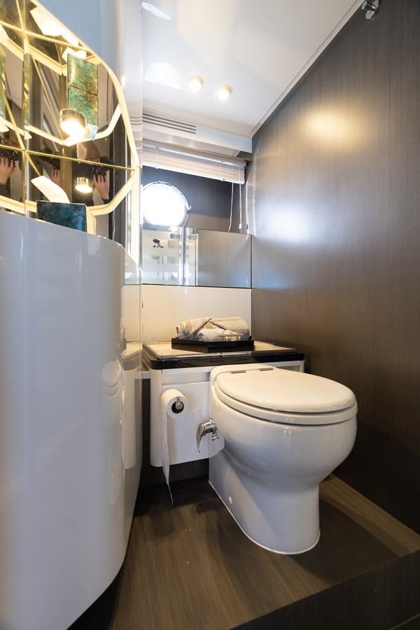 a bathroom with a toilet and a sink aboard ZERO DIMENSION Yacht for Sale