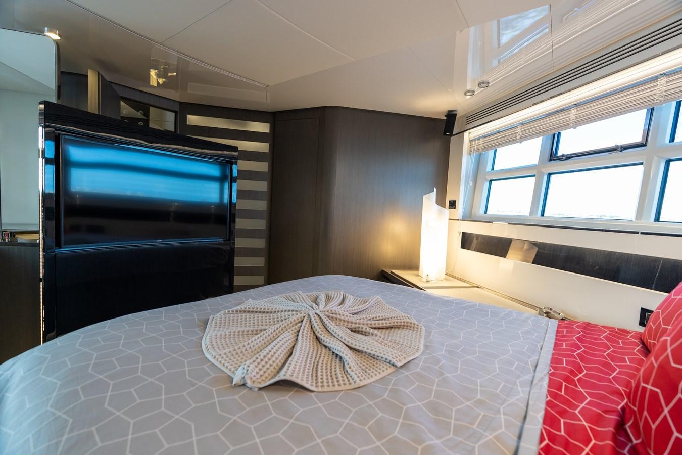 a room with a tv and a bed aboard ZERO DIMENSION Yacht for Sale
