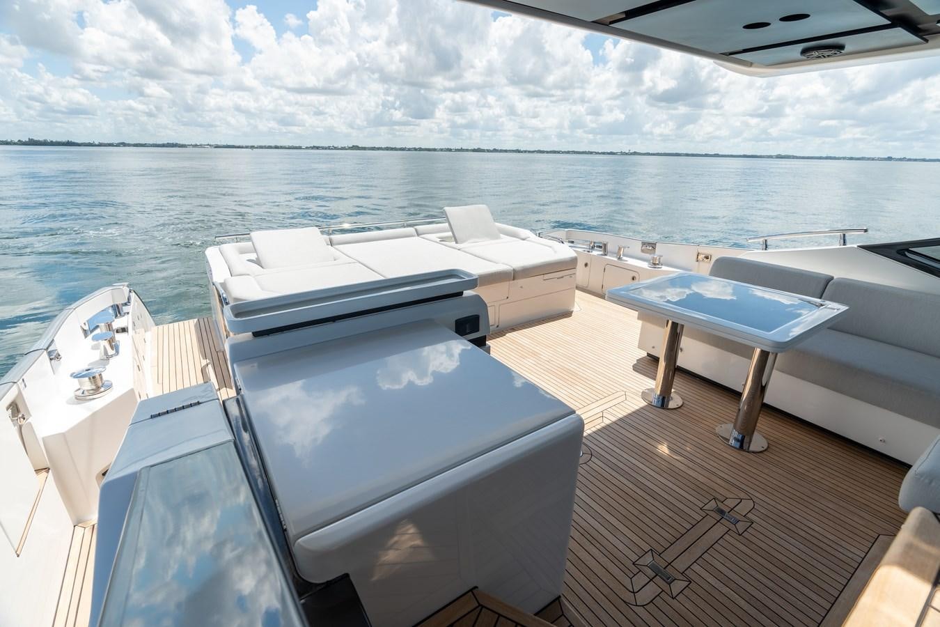 a deck with a pool and a deck with chairs and tables on it aboard ZERO DIMENSION Yacht for Sale