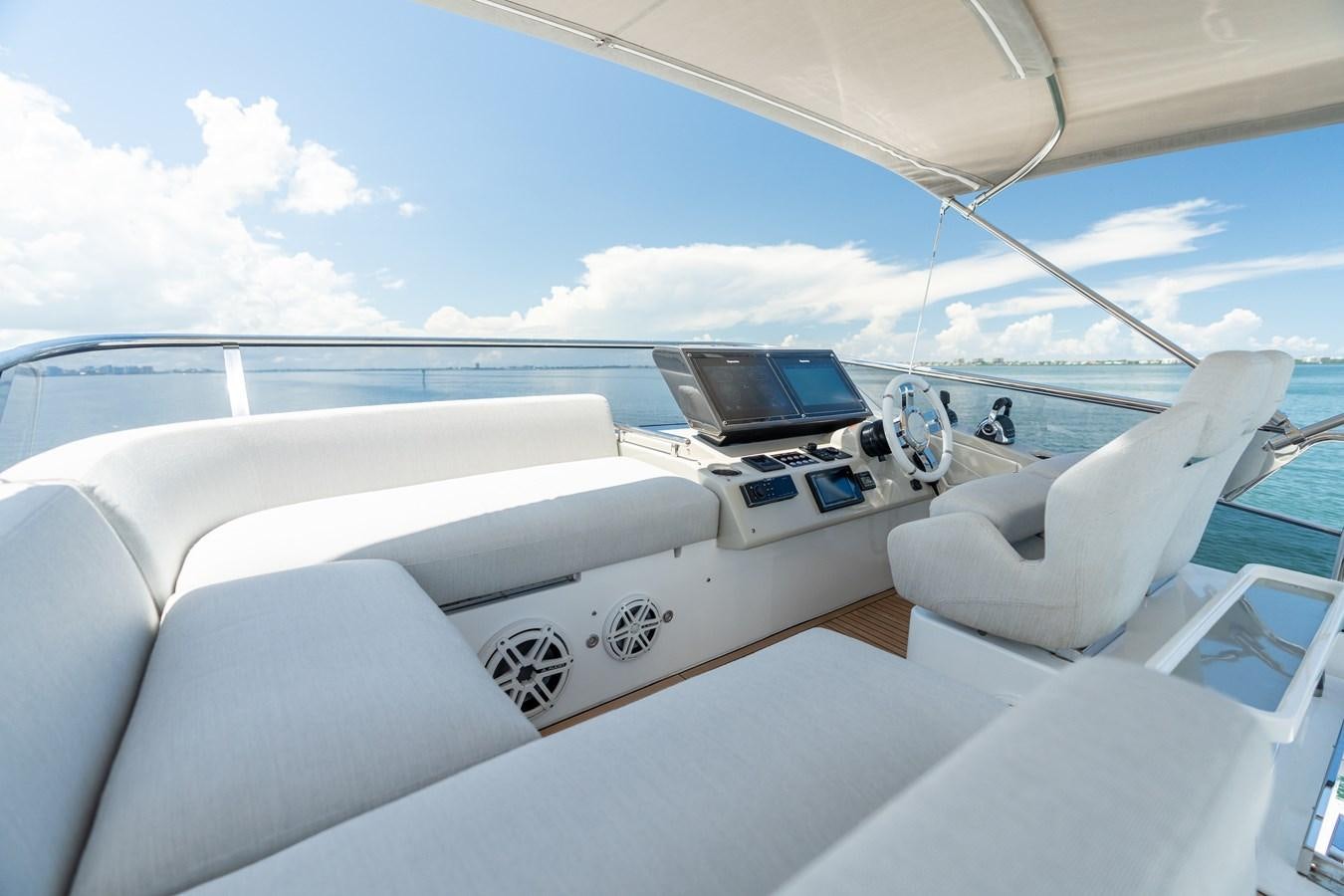 a white yacht with a laptop on the deck aboard ZERO DIMENSION Yacht for Sale