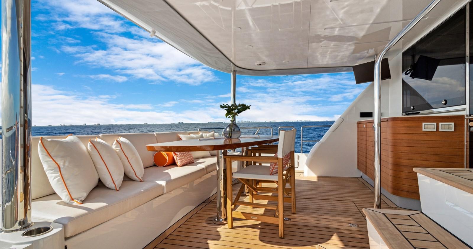 a room with a table and chairs aboard CLB65 Yacht for Sale
