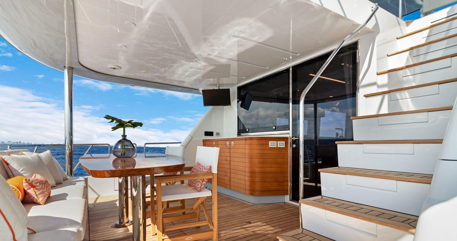 a room with a table and chairs aboard CLB65 Yacht for Sale