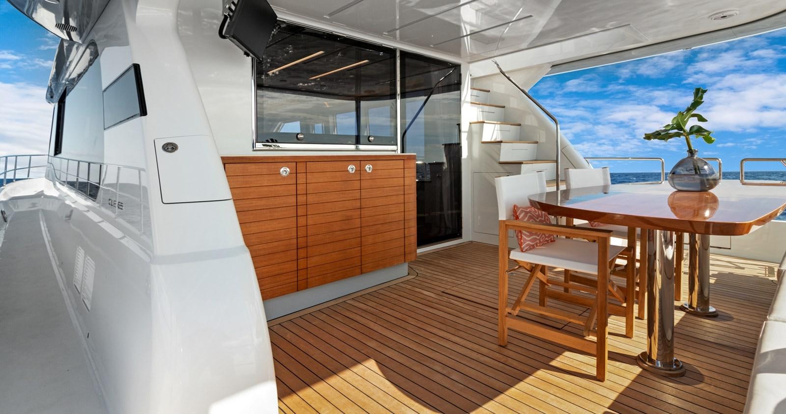 a room with a table and chairs aboard CLB65 Yacht for Sale
