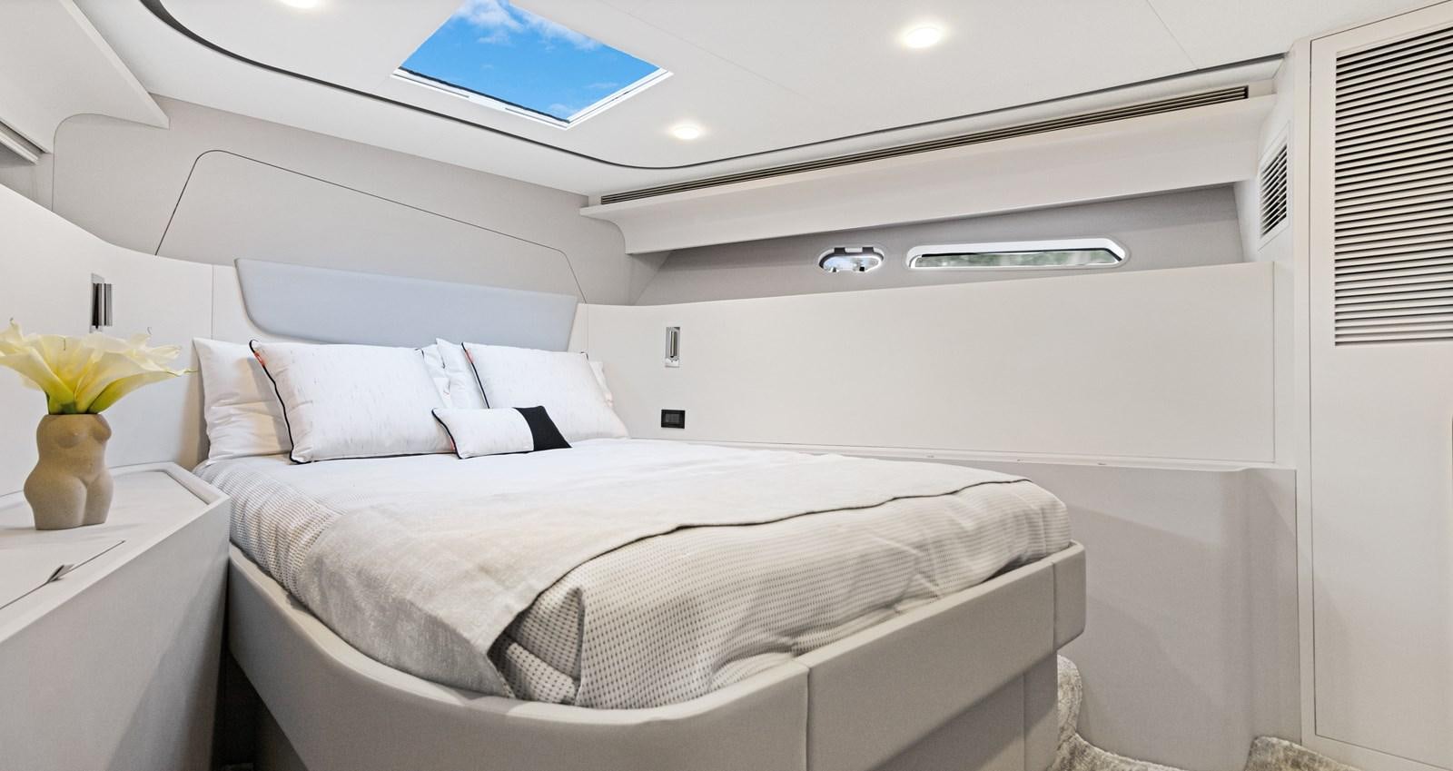 a white bed with white sheets aboard CLB65 Yacht for Sale