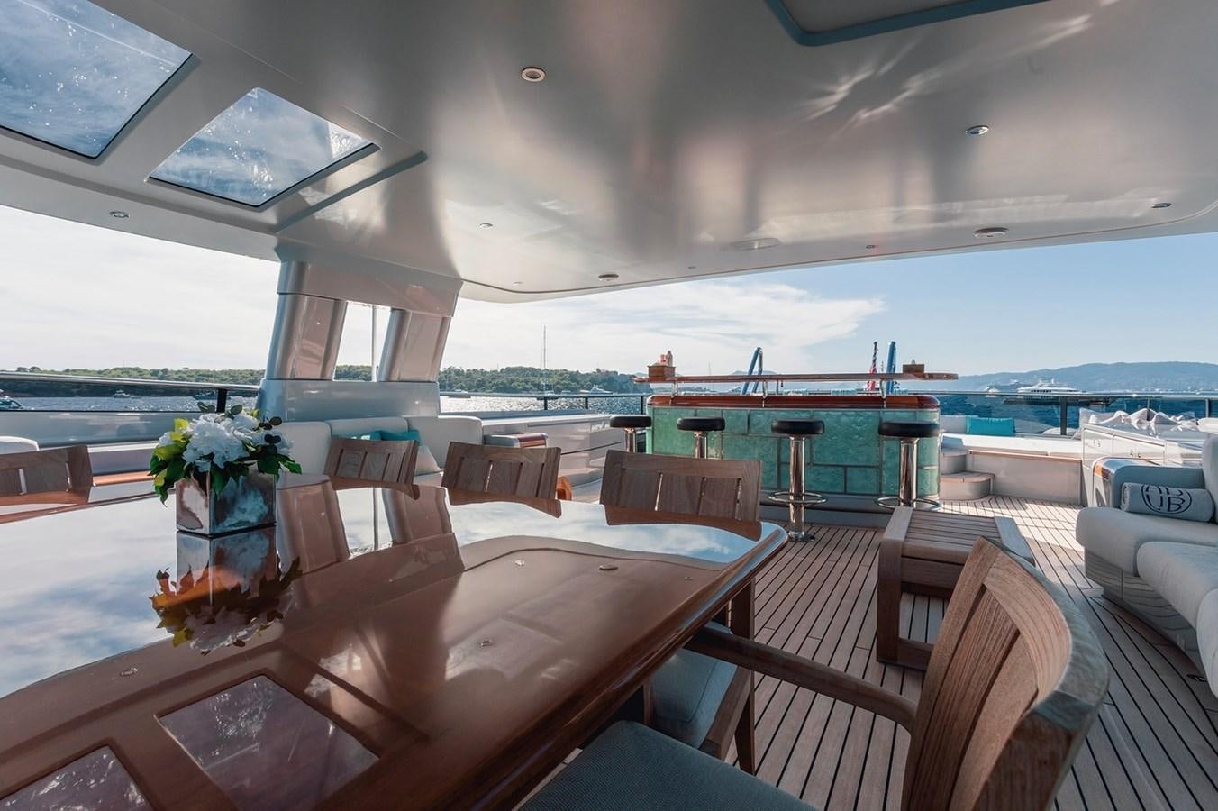 a table with chairs on it aboard AD LIB Yacht for Sale