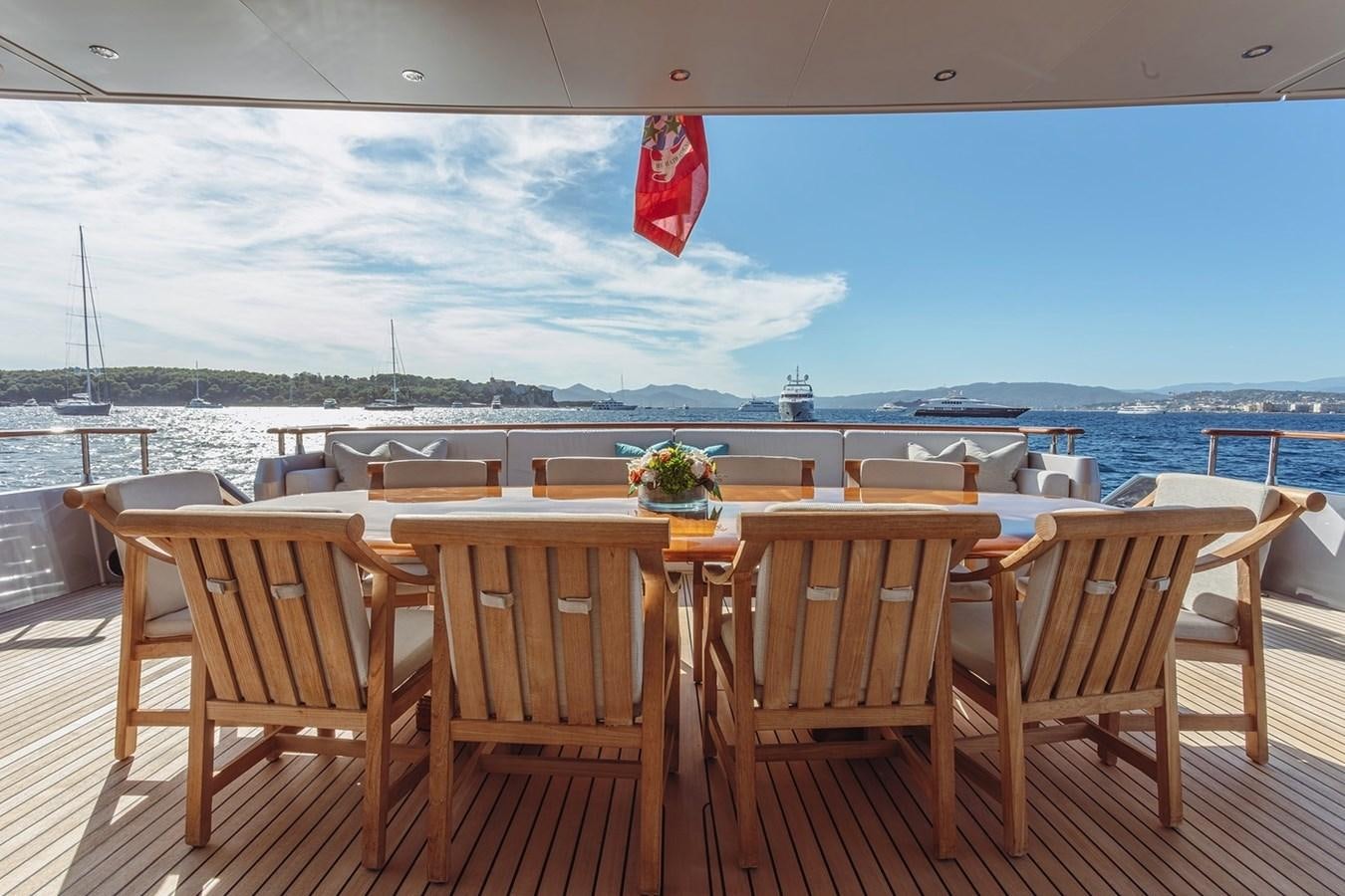 a table and chairs on a deck aboard AD LIB Yacht for Sale