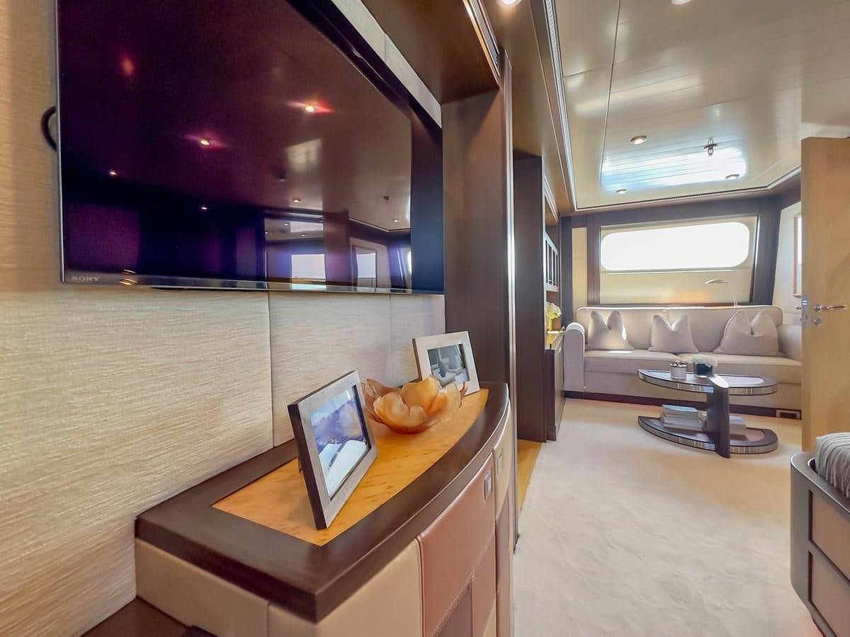 a room with a table and a couch aboard AD LIB Yacht for Sale
