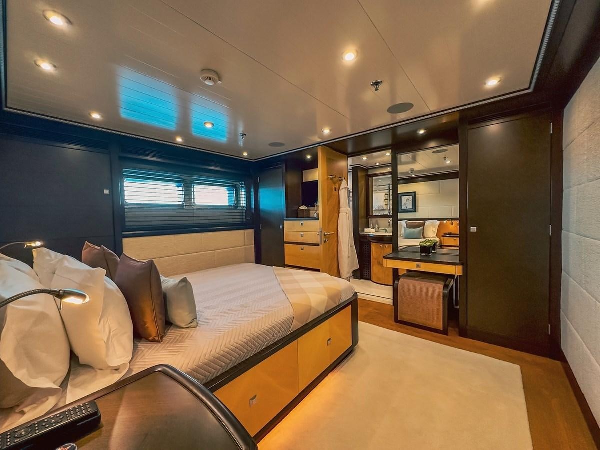 a bedroom with a bed and a desk aboard AD LIB Yacht for Sale