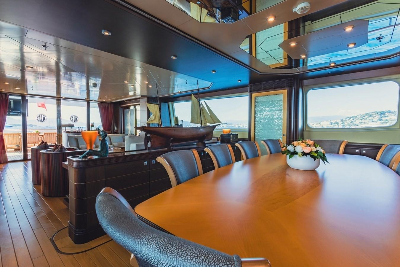 a large room with a table and chairs aboard AD LIB Yacht for Sale