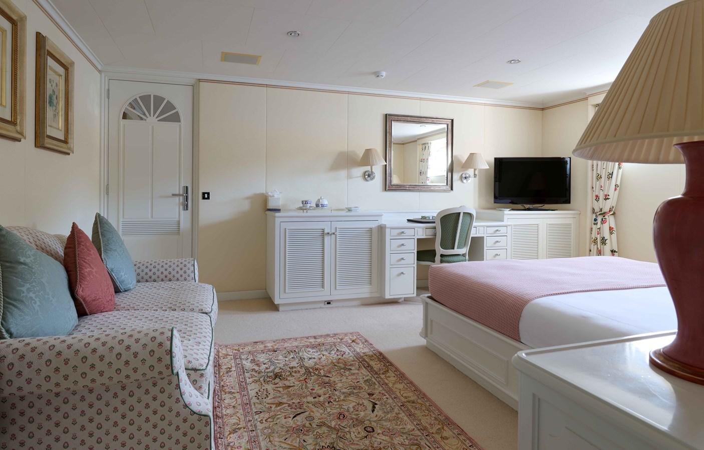a bedroom with a bed and a couch aboard LADY BEATRICE Yacht for Sale