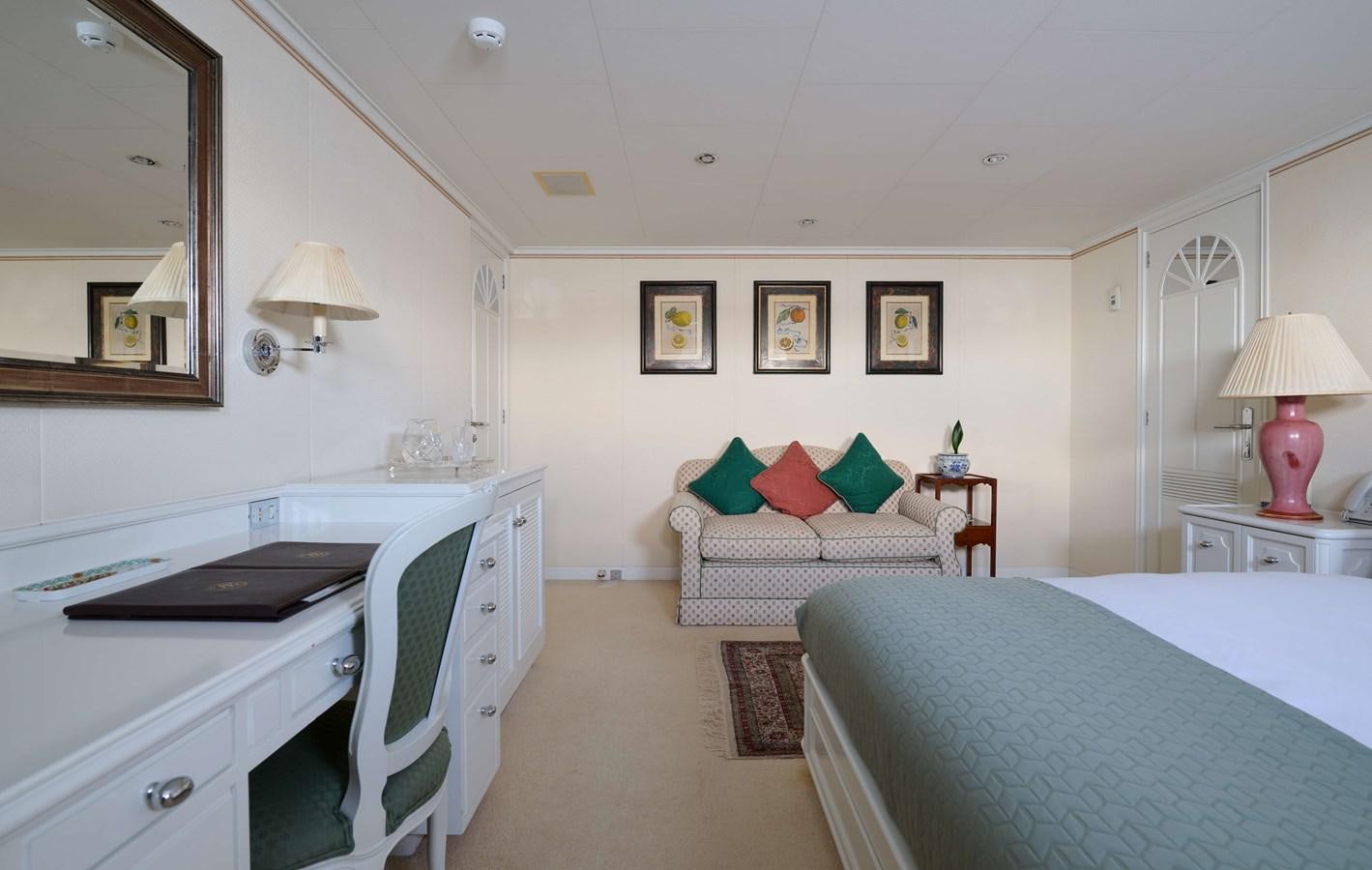 a bedroom with a bed and a desk aboard LADY BEATRICE Yacht for Sale