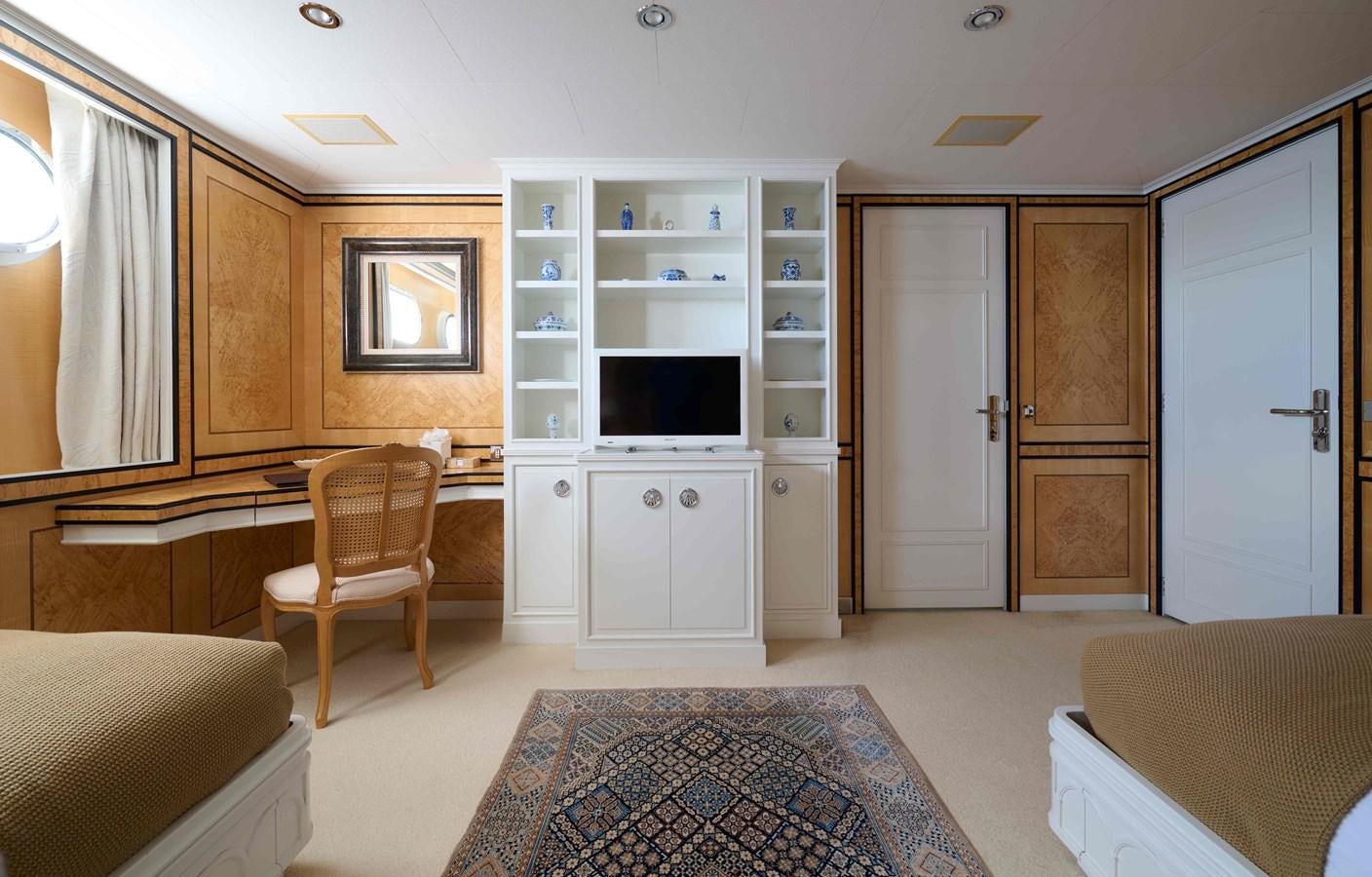 a room with a bed and a desk aboard LADY BEATRICE Yacht for Sale