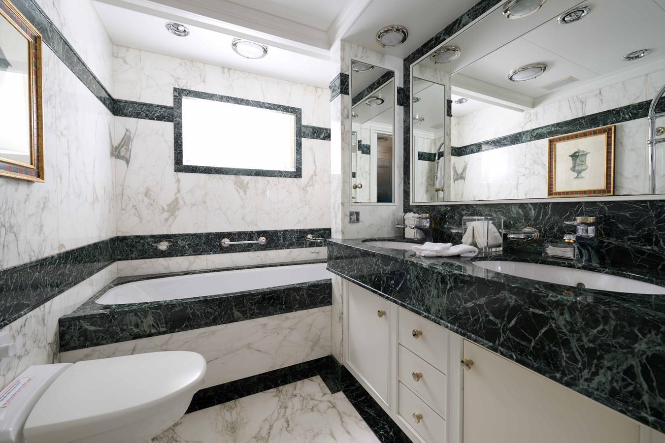 a bathroom with a tub sink and a sink aboard LADY BEATRICE Yacht for Sale