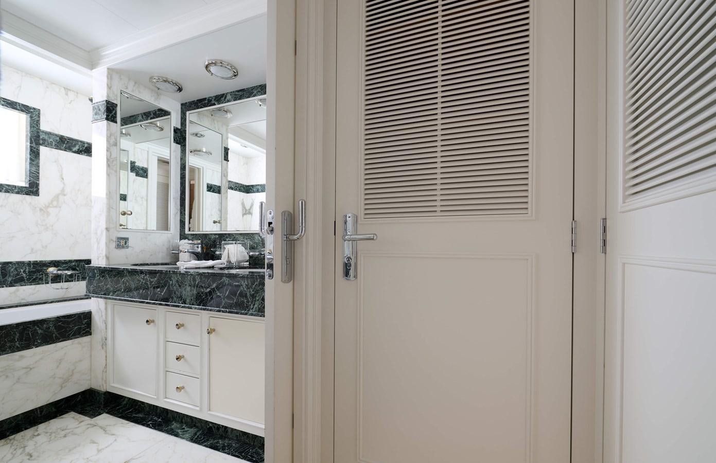 a kitchen with white cabinets aboard LADY BEATRICE Yacht for Sale