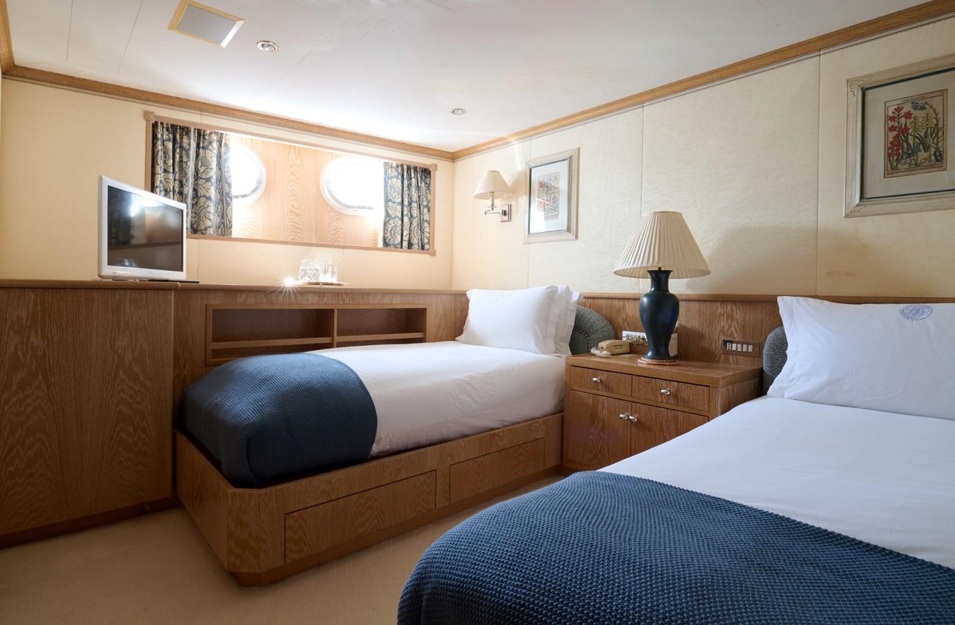 a hotel room with two beds aboard LADY BEATRICE Yacht for Sale
