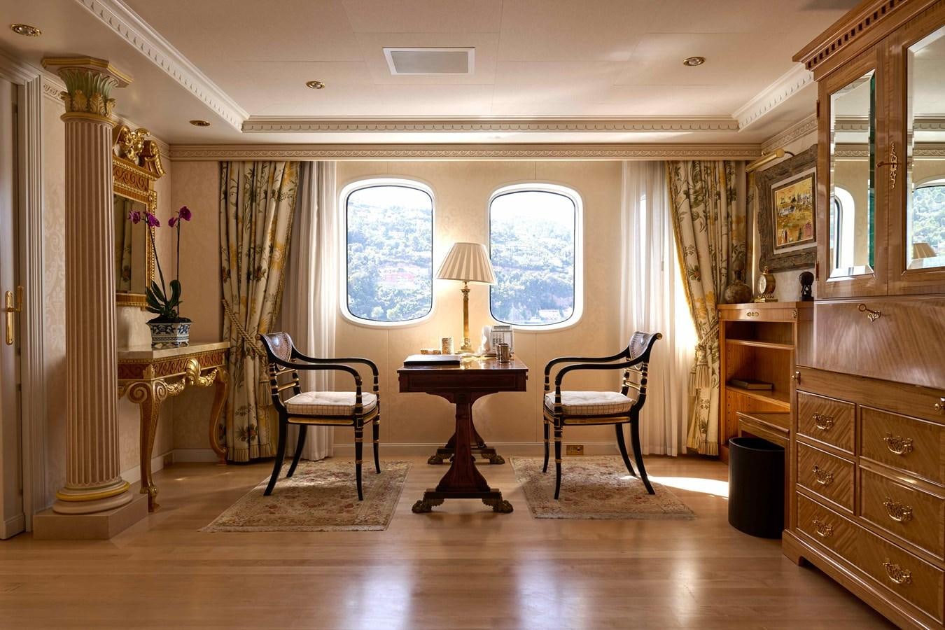 a room with a table chairs and a window aboard LADY BEATRICE Yacht for Sale