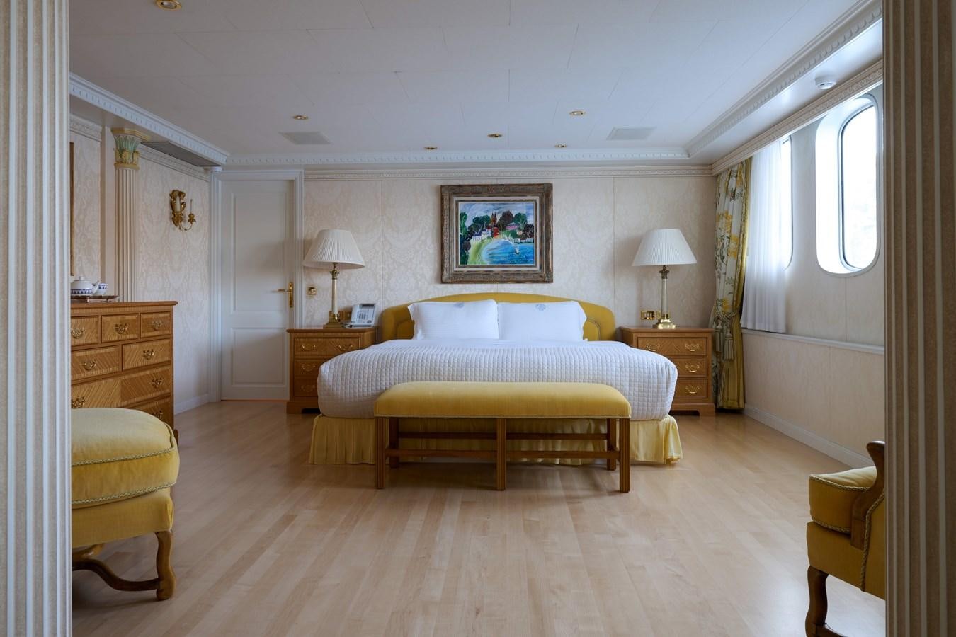 a bedroom with a bed and a lamp aboard LADY BEATRICE Yacht for Sale
