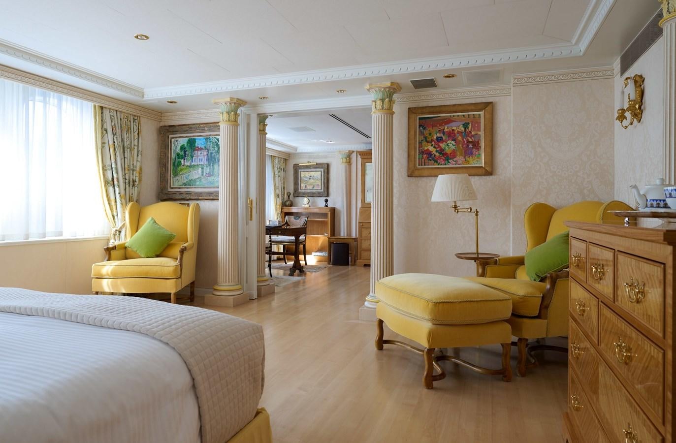 a bedroom with a bed and a desk aboard LADY BEATRICE Yacht for Sale