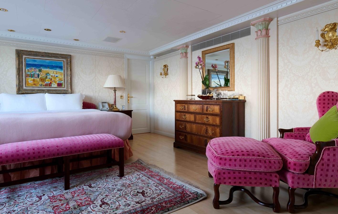 a bedroom with a bed and a desk aboard LADY BEATRICE Yacht for Sale