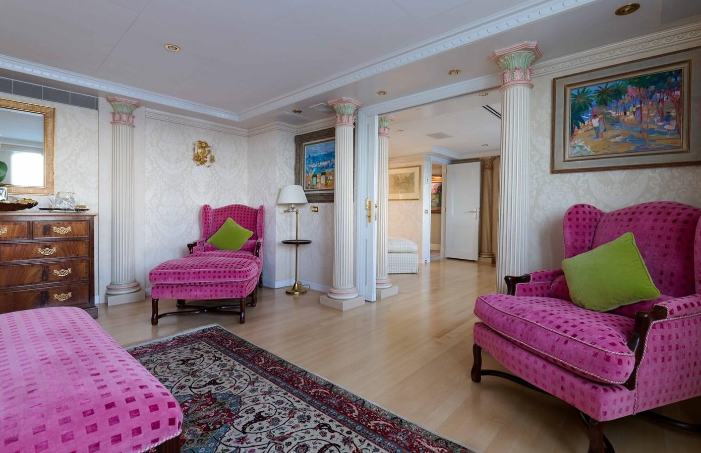 a large living room with pink furniture aboard LADY BEATRICE Yacht for Sale