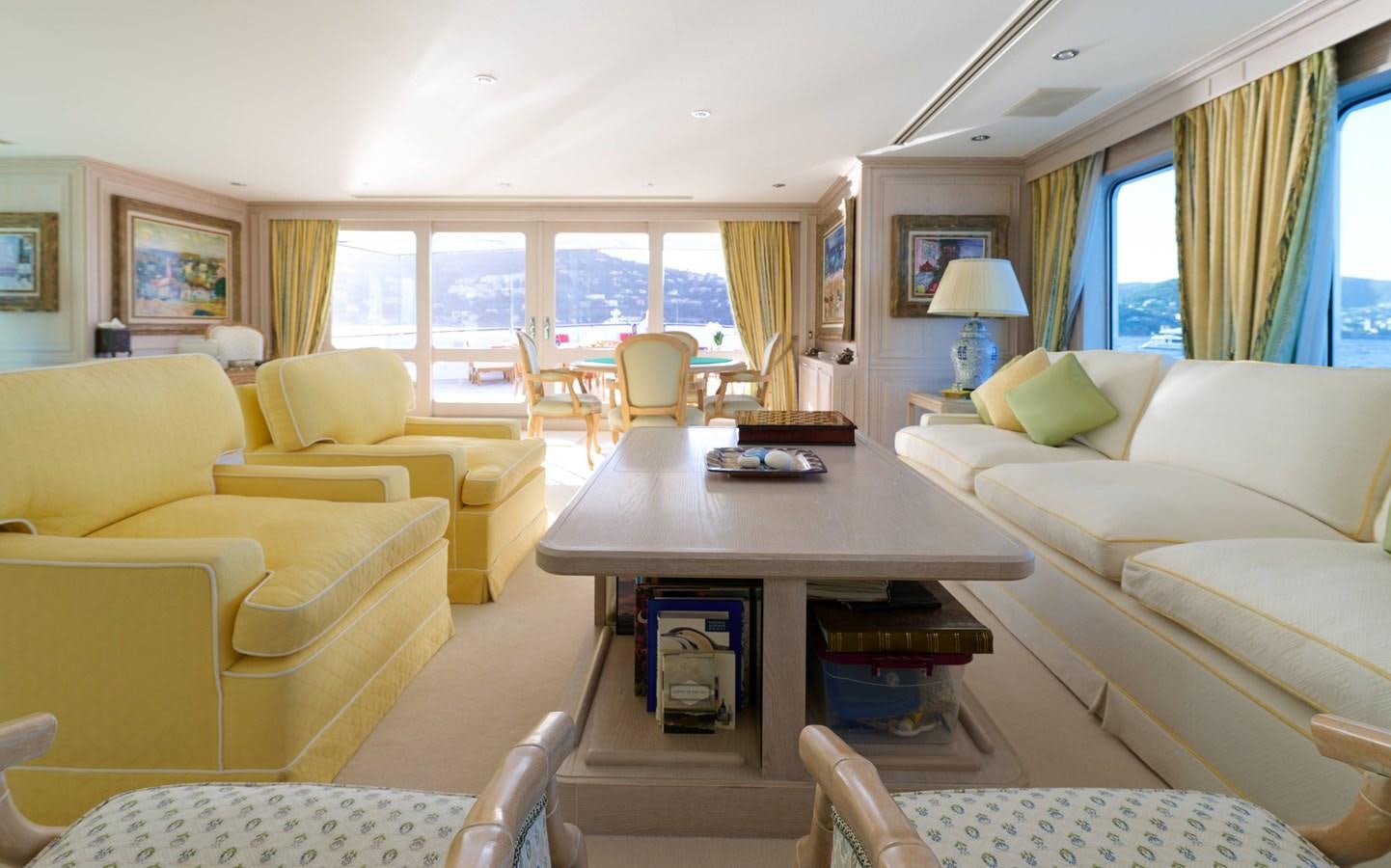 a living room with yellow couches aboard LADY BEATRICE Yacht for Sale