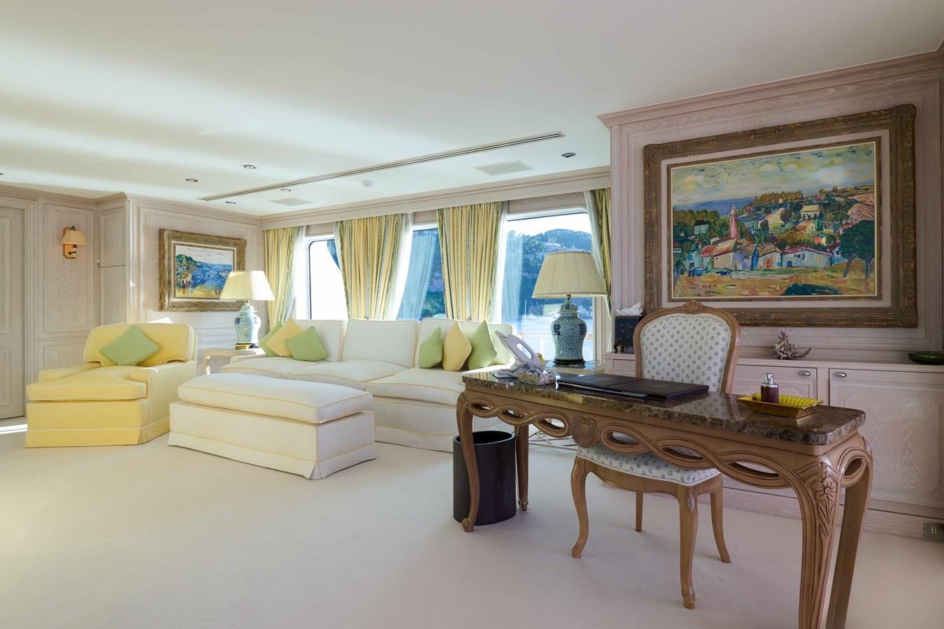 a living room with a table and couches aboard LADY BEATRICE Yacht for Sale