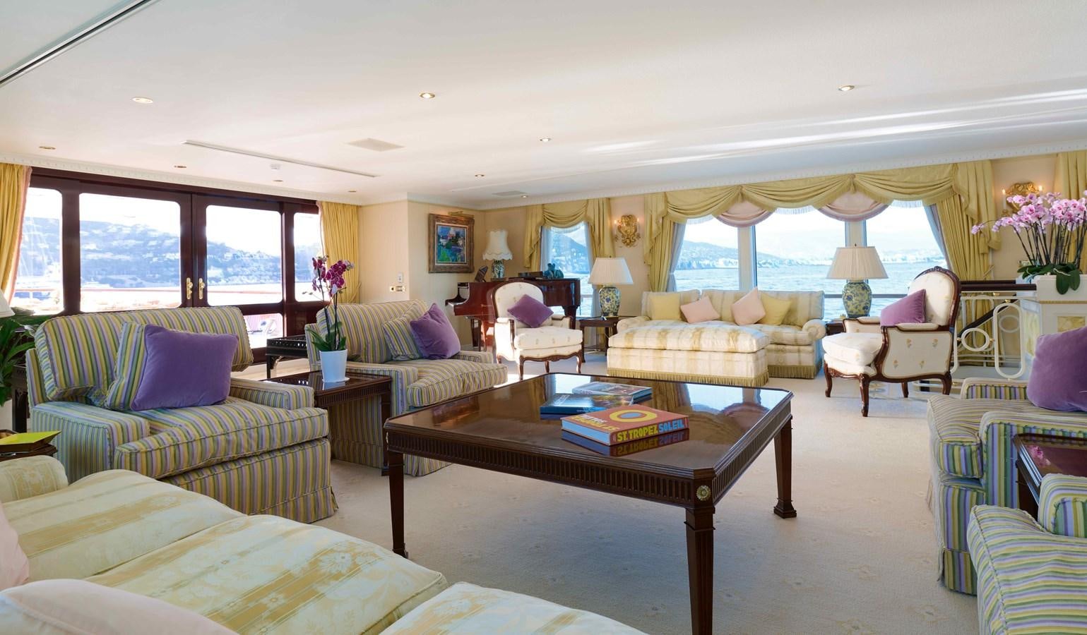 a living room with a couch and a coffee table aboard LADY BEATRICE Yacht for Sale