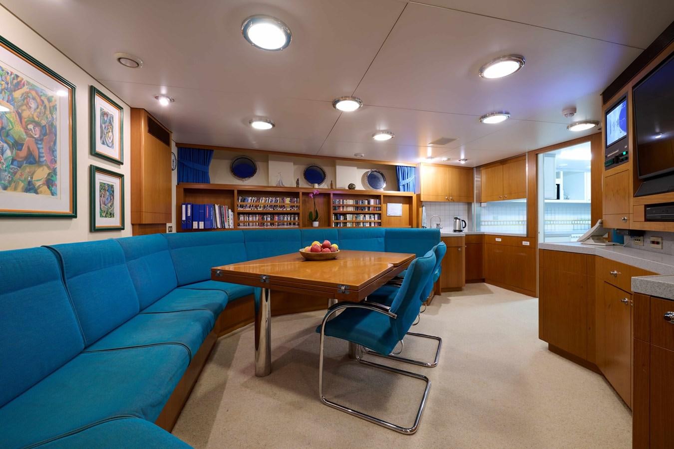 a room with a table and a couch aboard LADY BEATRICE Yacht for Sale