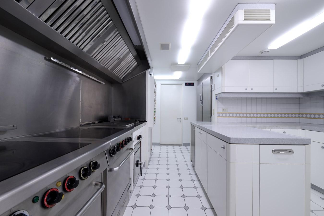 a kitchen with white cabinets aboard LADY BEATRICE Yacht for Sale